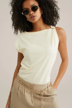 jersey top met gouden accenten